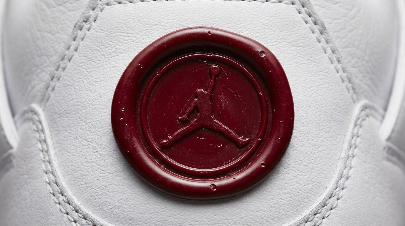 Close-up of a red wax seal stamped with the Jumpman logo on premium white leather texture